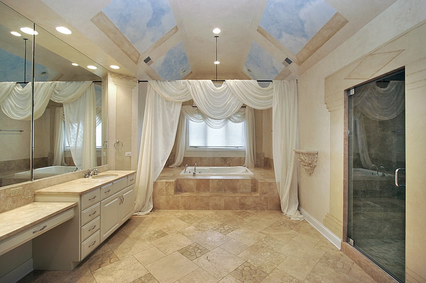 It is the extensive use of faux stone tiles in the floor and the main shower area that makes this master bathroom stand out. The cream color of wood and countertop used in the cabinetry matches with the overall trend .