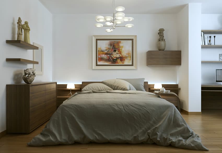 A simple bedroom that makes use of fewer furniture. The floor, cabinets and side tables are all of natural wooden color. The white painting on the wall soothes the eyes.