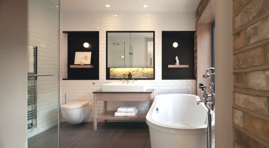 The black artistic accents by the sides of the mirror that set the tone for this splendid bathroom.