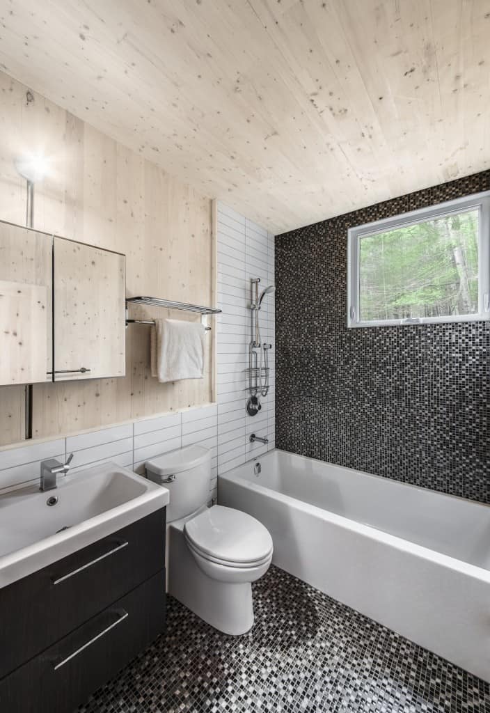 A small but ultra-modern bathroom uses unstained pine quite heavily while the upper cabinet is wooden and rusty .