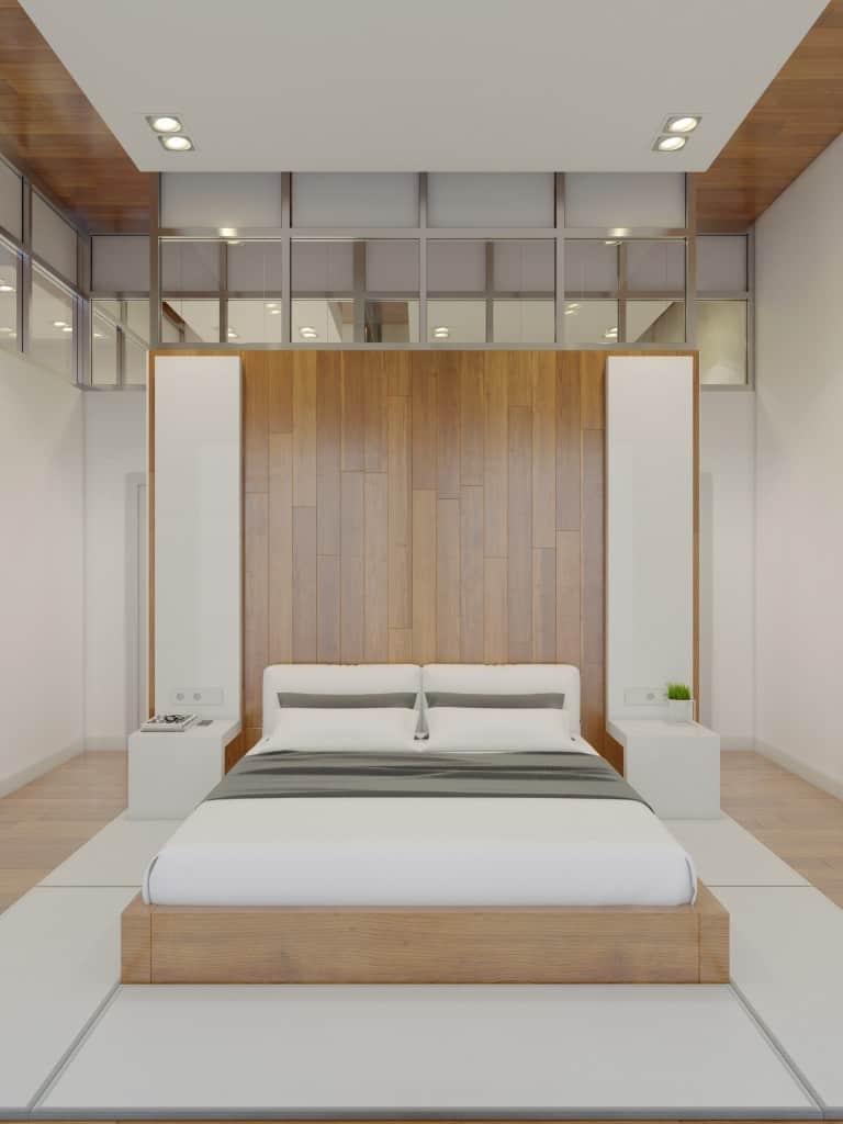 A symmetric minimalist bedroom that is picture perfect . It makes use of very little furniture. Natural hard wooden floor give way to white granite floor at the center.