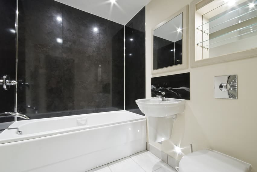 Black walls look awesome in bathrooms. The all black wall that makes use of large black granites gives the bathtub area a glossy look.