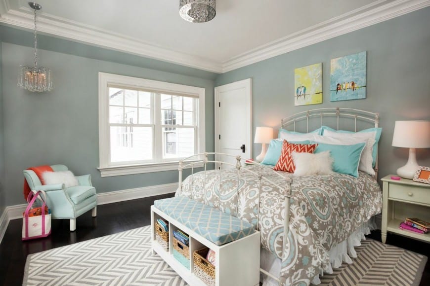 A feminine bedroom that coveys a message of comfort and peace. A cool combination of grey and light blue along with the zigzag rug over dark floor makes this room even more lively.