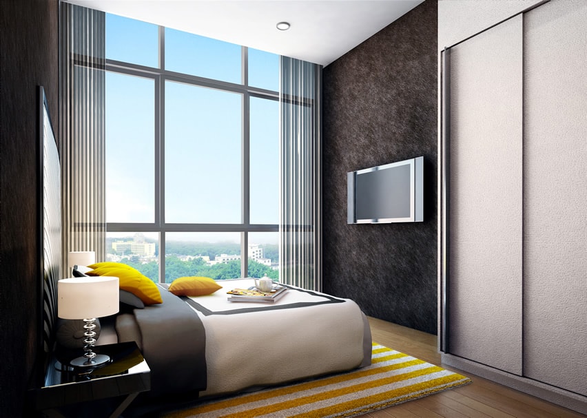 This extremely modern bedroom uses dark color and yellow cushions to introduce vibrancy and playfulness. The metallic wallpapers used are striking . A more playful atmosphere is introduced with black and white fabrics and yellow striped rug.