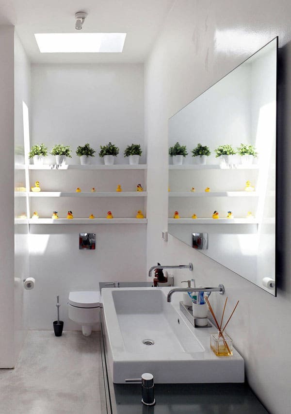Even if your bathroom is pretty small, you can make it pop with potted plants and light colored backsplash .